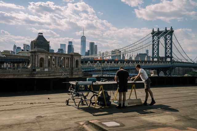 A photo of two people on a roof in DUMBO
